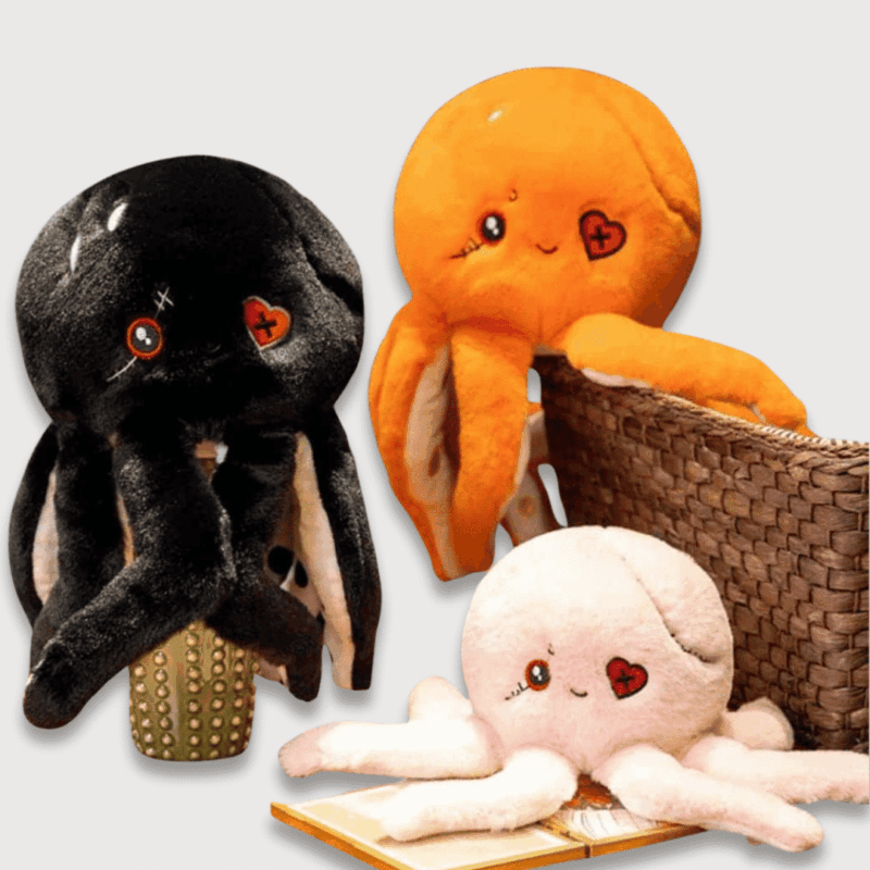 Doudou Poulpe Halloween de Dark Butter 24 cm : Trois doudous poulpes noirs, oranges et roses avec un œil en forme de cœur.