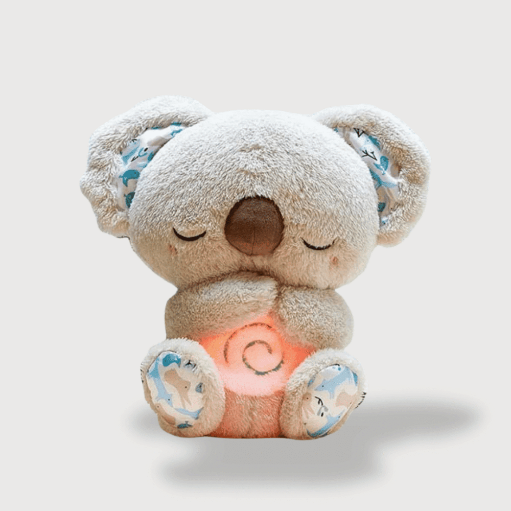 Doudou Koala Musical 30 cm beige avec des oreilles étoilées et un ventre lumineux en spirale.