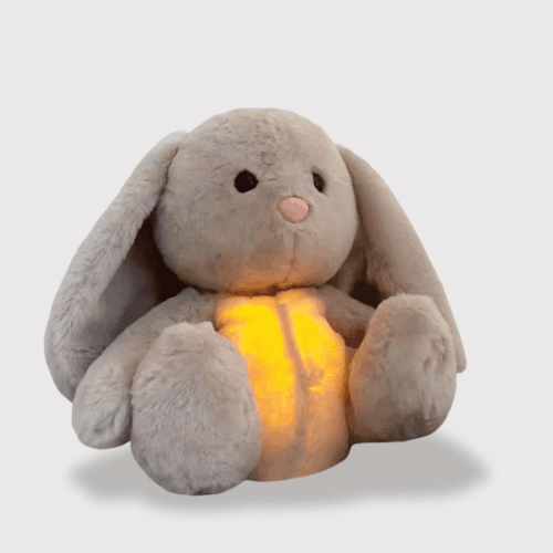 Doudou Lapin Apaisant Respire 25 cm gris, aux longues oreilles tombantes et une lumière relaxante sur le ventre.