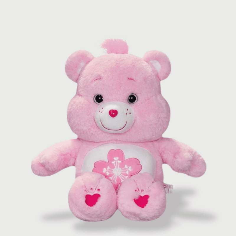 Doudou Rose Kawaii en forme d'ourson rose moelleux, avec un sourire tendre et un cœur sur le ventre.
