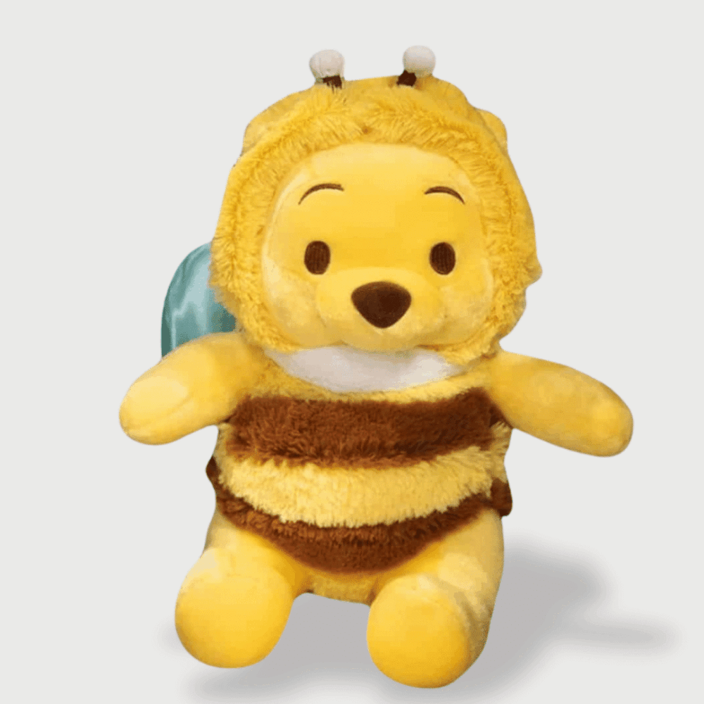 Doudou Winnie L'Ourson Déguisé en Abeille 35 cm, habillé en abeille avec des ailes bleues et un costume rayé jaune et brun.
