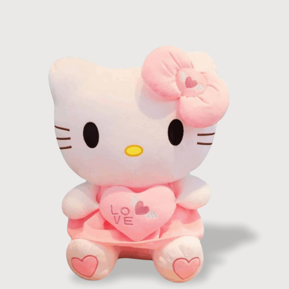 Doudou Kittie Géant de 65 cm : Un grand doudou Hello Kitty rose tenant un coussin en forme de cœur avec l'inscription "LOVE".