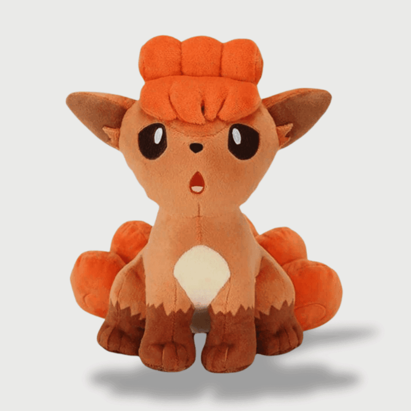 Doudou Pokemon Goupix : Un doudou Goupix orange avec six queues bouclées et une expression curieuse.
