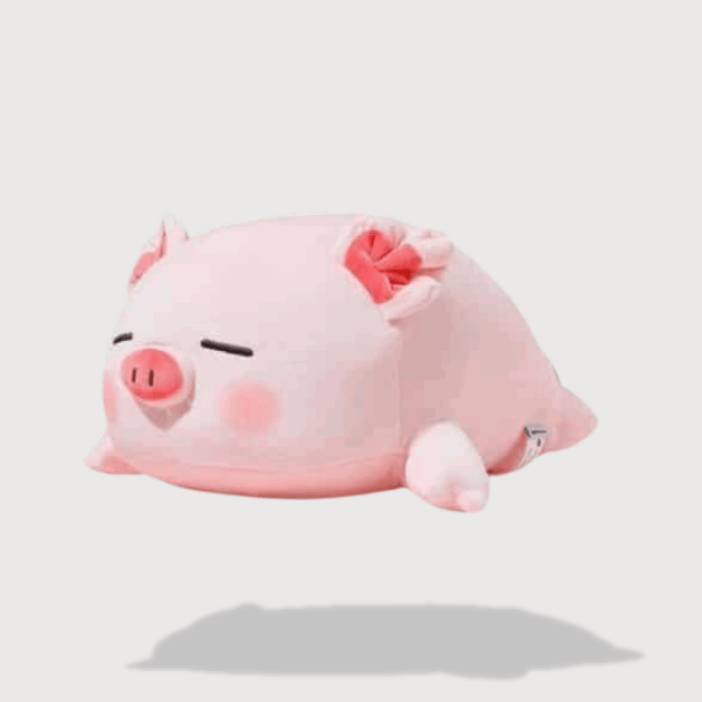 Doudou Rose Cochon Dormant allongé avec les yeux fermés, joues roses, petites oreilles et un nœud sur la tête.
