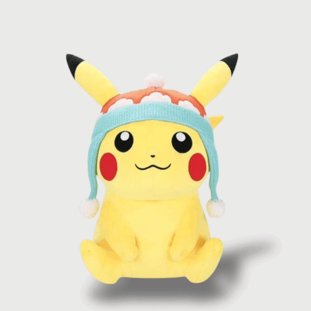 Doudou Pikachu avec un Bonnet D'Hiver : Un doudou Pikachu jaune portant un bonnet tricoté bleu et blanc avec des pompons.