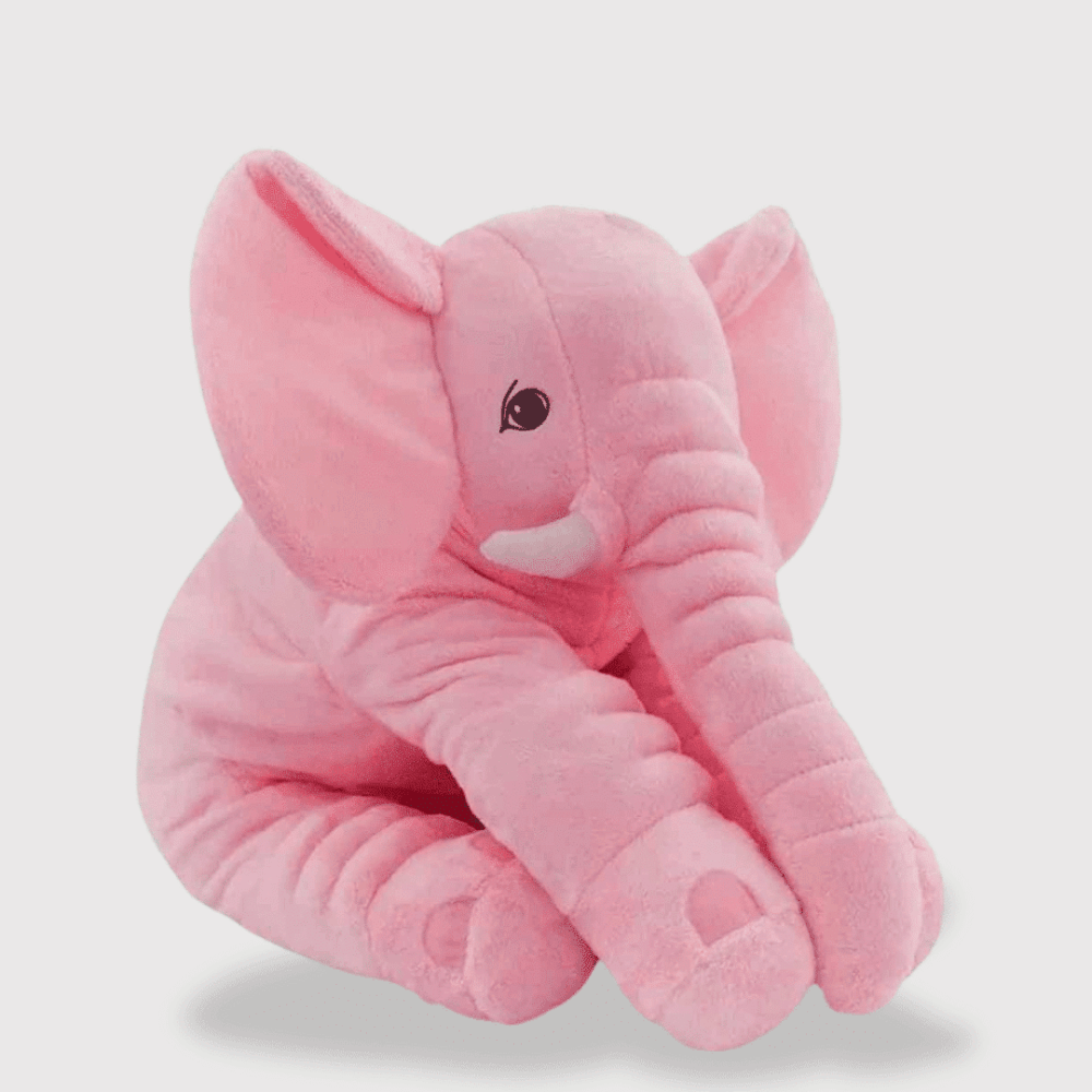 Doudou Elephant de Haute Qualité : Un doudou éléphant rose avec de grandes oreilles et une trompe allongée, allongé avec un regard tendre.